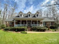 Charming brick home with a welcoming front porch and well-manicured lawn at 501 Colonels Ct, Clover, SC 29710