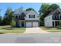Charming two-story home with a two car garage, well-manicured lawn and neutral color scheme at 5056 Blue Serenity Ct, Denver, NC 28037