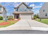Charming two-story home featuring a two-car garage and manicured front lawn at 530 Silers Bald Dr, Fort Mill, SC 29715