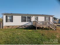 Charming home with vinyl siding, stone accent, and a welcoming front deck at 5448 Bill Sain Rd, Vale, NC 28168