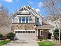 Charming two-story home featuring a stone facade, neutral siding, and a well-maintained front yard at 5915 Glenmore Garden Dr, Charlotte, NC 28270
