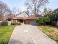Charming home featuring a long concrete driveway and a well-maintained lawn at 6200 Summertree Ln, Charlotte, NC 28226