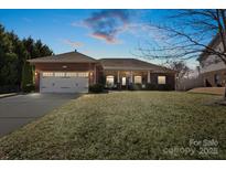 Charming brick home with a two-car garage and manicured front lawn offers curb appeal at 112 Jobe Dr, Statesville, NC 28677