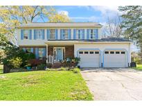 Charming two-story home featuring a well-maintained lawn, attached two-car garage, and light-blue shutters at 11416 Leadenhall Ln # 22, Charlotte, NC 28262