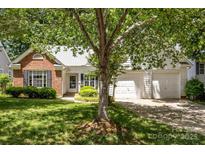 Charming single-Gathering home with brick and siding and a well-manicured lawn and two-car garage at 1286 Saint Katherines Way, Rock Hill, SC 29732