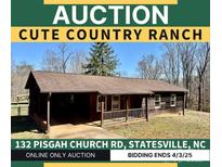 Charming ranch-style house featuring a cozy front porch and natural wood siding at 132 Pisgah Church Rd, Statesville, NC 28625
