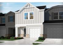 Charming home with a two-car garage, grey siding, and well-manicured landscaping at 1732 Braemar Village Dr, Monroe, NC 28110