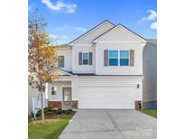 Charming two-story home with a large attached two car garage and manicured lawn at 2202 Catawba Trace Dr, Catawba, NC 28609