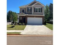 Two-story home featuring a two-car garage, brick and siding, and manicured lawn at 2202 Catawba Trace Dr, Catawba, NC 28609