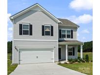 Charming two-story home features a two-car garage and inviting front porch at 2223 Catawba Trace Dr, Catawba, NC 28609