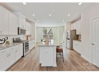 Modern kitchen featuring a large island, stainless steel appliances, and ample cabinet space at 2610 Greenmarket Dr, Charlotte, NC 28217