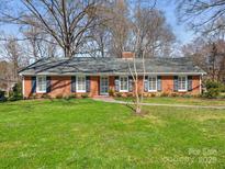 Charming brick home features a well-manicured lawn and classic shutters at 3329 Cornish Pl, Charlotte, NC 28210