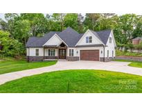Charming home featuring a stone-accented facade, gabled roof, and attached garage at 3732 Whitney Ne Dr, Hickory, NC 28601