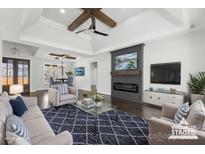 Bright open living space featuring a modern fireplace, hardwood floors and stylish decor at 3732 Whitney Ne Dr, Hickory, NC 28601