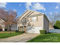 Charming two-story home with tan siding, a two-car garage, and a well-manicured front lawn at 4526 Austin Dekota Dr, Charlotte, NC 28269