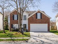Charming two-story brick home with a well-manicured lawn and attached two car garage at 4982 Bentgrass Run Dr, Charlotte, NC 28269