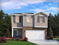 Two-story home featuring gray siding, brick accents, and a two-car garage at 5013 Poplin Vly, Cherryville, NC 28021