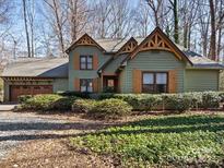 Charming craftsman-style home with green siding, wood shutters, and a well-manicured front yard at 5053 Marci Ln, Belmont, NC 28012