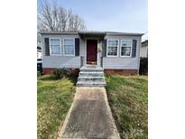 Charming single-story home with a well-maintained lawn and a red front door at 508 Elm St, Salisbury, NC 28144