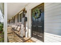 Charming front door with a wreath, sitting area, and decorative accents, creating a welcoming entrance at 1224 Green Oaks Ln # I, Charlotte, NC 28205
