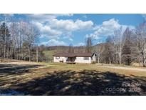 Charming single-story home with a cozy porch and beautiful natural surroundings on a sunny day at 1366 Vashti Rd, Taylorsville, NC 28681