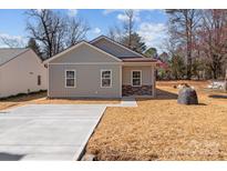 Charming single-story home with stone accents and a well-manicured lawn, offering a welcoming curb appeal at 140 Swimmers Ln, Salisbury, NC 28146