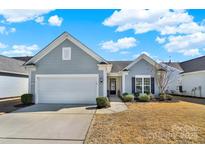 Charming single-story home featuring a two-car garage, and well-maintained landscaping at 2035 Vermount Way, Fort Mill, SC 29707