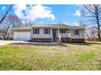 Charming single-story home featuring a welcoming porch, attached garage, and well-maintained lawn at 276 Rumple Hill Dr, Statesville, NC 28677