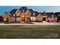 Stately brick home with manicured lawn, stone accents, and an arched entryway at 3200 Beaty Rd, Gastonia, NC 28056