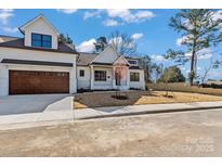 Charming two-story home featuring a two-car garage and freshly seeded front yard at 3328 Flamingo Ave, Charlotte, NC 28205