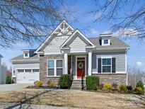 Charming home with a red front door, stone accents, and a well-manicured front yard at 5059 Saint Clair St, Fort Mill, SC 29715