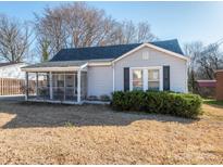 Charming single-story home with grey siding, a screened porch, and well-maintained landscaping at 707 Oakshade Ave, Kannapolis, NC 28083