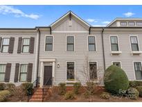 Charming two-story townhome with gray siding, dark shutters, and inviting front entrance at 118 Mint Ave # B, Mooresville, NC 28117