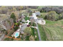 Expansive aerial view of an estate featuring multiple buildings, a pool, and picturesque landscaping at 1620 London Rd, Mooresville, NC 28115