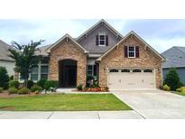 Beautiful stone and siding home with manicured lawn and two-car garage offers great curb appeal at 17436 Langston Dr, Charlotte, NC 28278