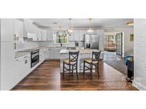 Bright, modern kitchen with white cabinets, stainless appliances, and a breakfast bar at 2052 10Th Street Nw Pl, Hickory, NC 28601