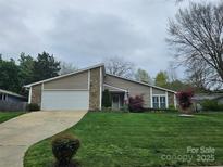 Charming ranch-style home with a two-car garage and beautifully manicured front lawn at 319 Vista Grande Cir, Charlotte, NC 28226