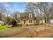 Charming yellow two-story home with a red front door and a well-maintained front yard at 3419 Arrow Ln, Charlotte, NC 28227