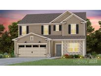Charming two-story home features stone accents, a two-car garage, and a well-manicured lawn at 3874 Pee Dee St # 49, Monroe, NC 28110