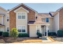 Inviting two-story townhouse featuring a brick and siding facade with well-maintained landscaping at 7803 Davinci Ln # B, Charlotte, NC 28226