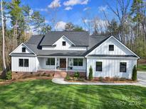 Inviting exterior of a modern farmhouse featuring a brick foundation and fresh green lawn at 856 Bellegray Rd, Clover, SC 29710