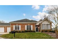 Charming brick home featuring white shutters and a well-maintained lawn, perfect for curb appeal at 11406 Olde Turnbury Ct, Charlotte, NC 28277