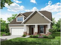 Charming new construction home with stone accents, covered porch, and well-maintained landscaping at 121 N Prestwick Way # 43, Mooresville, NC 28115