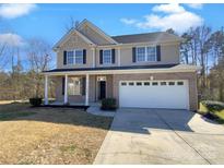 Charming two-story home with a brick and siding exterior, complemented by a well-maintained front yard and two car garage at 13603 Whitebark Ct, Charlotte, NC 28262