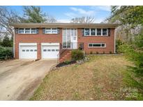 Charming red brick home with a well-manicured lawn and a two-car garage offers classic curb appeal at 1525 16Th Avenue Nw Cir, Hickory, NC 28601