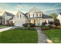Charming two-story home with landscaped yard, attached garage, and inviting green front door at 1730 Townsend Ln, Rock Hill, SC 29730
