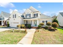 Charming two-story home featuring a manicured lawn, a bright green front door, and a welcoming walkway at 1730 Townsend Ln, Rock Hill, SC 29730