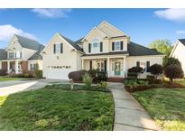 Charming two-story home with a manicured lawn, attached garage, and inviting front porch at 1730 Townsend Ln, Rock Hill, SC 29730