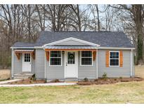 Charming single-story home with gray siding, updated roof, and lovely front yard at 208 Hollifield St, Gastonia, NC 28056
