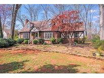Charming Tudor-style home with brick accents and a well-manicured front yard at 2324 Chestnut Ln, Matthews, NC 28104